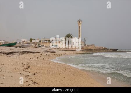 Bateaux de fshing, mosquée et minaret à la plage dans le village Fins , mer d'Oman, Sultanat d'Oman Banque D'Images