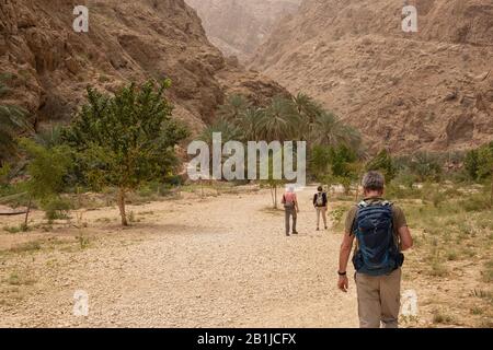 Les gens marchent sur un chemin à Wadi Shab en Oman Banque D'Images