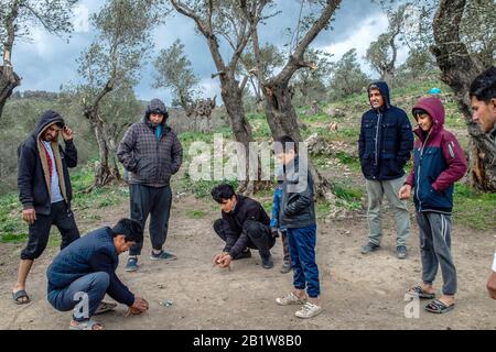 Lesbos, Grèce. 27 février 2020. Les migrants jouent avec des marbres dans un camp temporaire de tentes près du camp pour les migrants à Moria. Suite à de graves affrontements entre la police et les habitants en colère de l'île grecque de Lesbos, qui a fait des dizaines de blessés, le Premier ministre Mitsotakis a ordonné à la police anti-émeute de se retirer des îles. Crédit: Angelos Tzortzinis/Dpa/Dpa/Alay Live News Banque D'Images