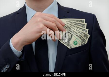 Main Geld Einstecken Dollars Banque D'Images