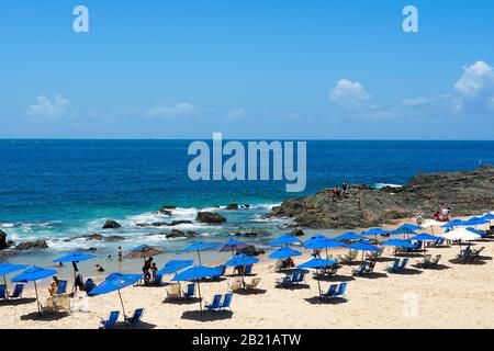 Les gens qui profitent du soleil, de la plage et de l'eau bleue à Porto da Barra Beach à côté du phare de Barra à Salvador Bahia Brésil. 22 février 2019 Banque D'Images