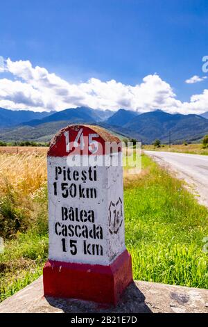 Jalon par une route, campagne en Roumanie. Mountines en arrière-plan, autoroute vide. Banque D'Images