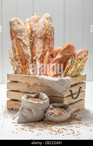 Baguettes dorées pour le petit déjeuner dans une boîte en bois Banque D'Images