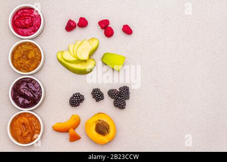 Assortiment de purée de fruits bio maison en bonne santé. Confiture, confiture, chutney ou sauce aux baies dans un bol en céramique. Concept de dessert sucré comme bébé FO Banque D'Images