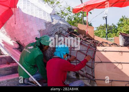 Les travailleurs de la construction travaillent sur des coffrages en acier de barre avant de couvrir avec des tuiles en béton et en marbre au Grand Bouddha, Phuket, Thaïlande. Banque D'Images