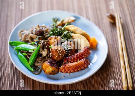 Repas japonais à bento avec boulettes de viande, saucisses et légumes Banque D'Images