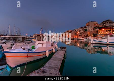 Vue panoramique sur le magnifique coucher de soleil dans la forteresse de Koules (Rocca a Mare), île de Crète. Yachts reflétant dans le miroir de l'eau près du vieux port vénitien Banque D'Images