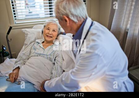 Femme âgée souriante regardant son médecin Banque D'Images