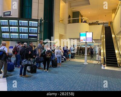 Orlando,FL/USA-2/27/20: Les gens qui attendent en ligne pour passer par l'aéroport international d'Orlando MCO sécurité TSA une journée chargée. Banque D'Images