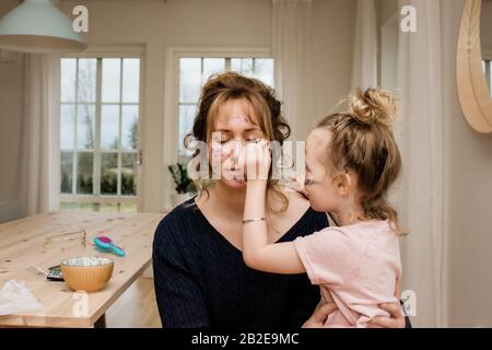 mère et fille jouant ensemble avec maquillage et paillettes Banque D'Images