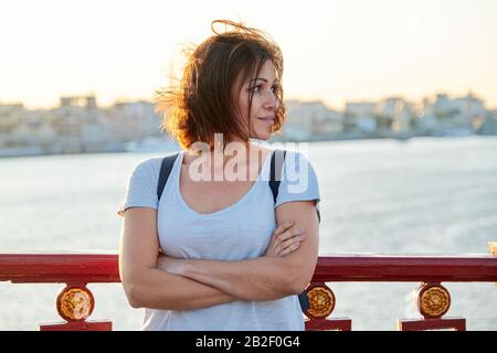 Portrait extérieur de belle femme mûre heureuse avec des bras croisés Banque D'Images