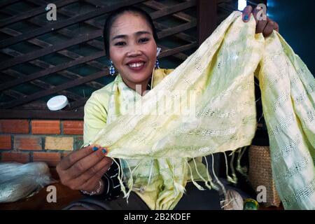 Siem Reap, Cambodge, Asie: Une femme montre un châle de soie dans les ateliers du projet Artisan Angkor Banque D'Images