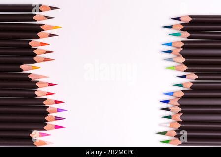 Bordure de peinture double face à partir de crayons multicolores sur fond blanc avec espace de copie. Vue de dessus. Banque D'Images