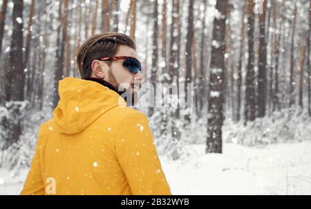 Homme marchant dans la forêt d'hiver Banque D'Images