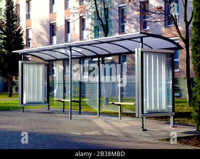 abri de bus à structure de verre. fond de maquette. pelouse verte et arbres. panneaux publicitaires en verre avec boîte lumineuse. espace publicitaire. concept marketing Banque D'Images