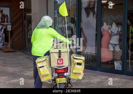 L'homme de poste australien livrant son vélo cyclomoteur honda à Lennox Head, Nouvelle-Galles du Sud, Australie Banque D'Images