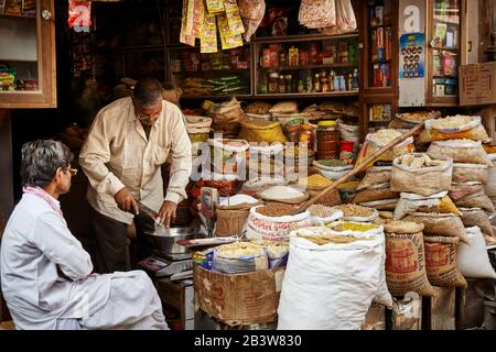 Deux hommes et sacs avec de la nourriture dans un magasin de Bikaner, Rajasthan, Inde Banque D'Images