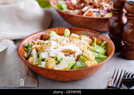 Salade César dans un bol en bois avec laitue, parmesan et croûtons Banque D'Images