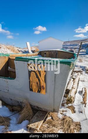 Art sculpté sur un vieux bateau de pêche en hiver dans le village historique de Ferryland, Terre-Neuve, Canada [pas de mainlevée de propriété; permis pour éditorial u Banque D'Images