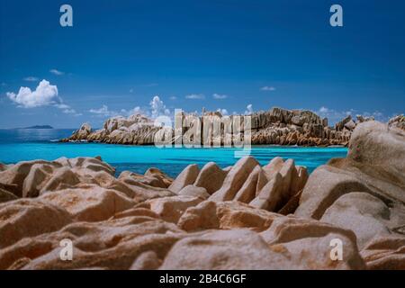 Seychelles La Digue. Paysage d'incroyables pierres de granit en forme énorme et bleu turquoise océan lagon. Banque D'Images