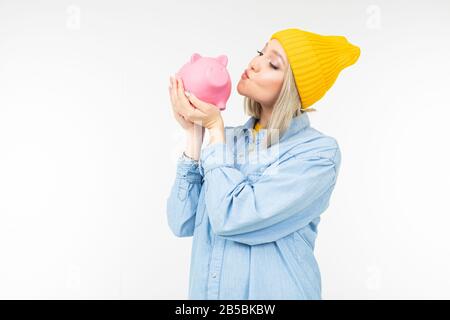 fille élégante dans une chemise bleue avec une banque pour économiser des finances sur un fond blanc avec espace de copie Banque D'Images