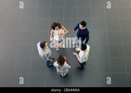 Groupe de gens d'affaires multiethniques gaies discutant des nouvelles, des commérages et des idées pendant la pause, vue d'en haut Banque D'Images