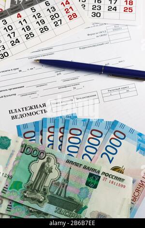 Paie, calendrier, stylo bille et billets de l'argent russe. Paiement des salaires Banque D'Images