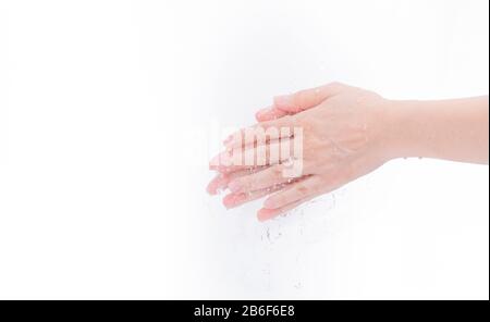 Femme se laver la main avec de l'eau isolée sur fond blanc. Bon concept d'hygiène personnelle. Première étape pour nettoyer les mains sales pour prévenir la grippe et la couronne Banque D'Images