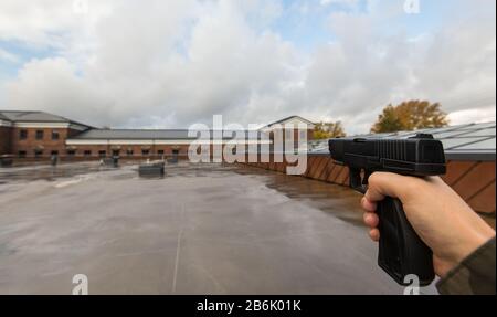 Concept de jeu de réalité virtuelle et de violence - POV de prises de vue des mains mâles avec canon semi-automatique à l'extérieur Banque D'Images