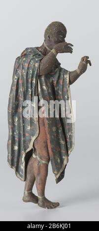 Un Hoop une figure lâche sur un diorama de Gerrit Schouten, représentant un homme créole debout tourné à droite. Il a levé les deux mains. L'homme porte un châle bleu décoré de motifs rouges et blancs et équipé d'une bande blanche. Il porte des bracelets et des anklets et pieds nus. L'attitude de ses mains suggère qu'à l'origine il a tenu une comédie musicale. Une figure très similaire d'un diorama d'une danse esclave en possession du Musée de la Barbade (Medendorp diorama XV) joue un benta, un instrument à cordes en forme d'arc ou fluit. Fabricant : fabricant: Gerrit Schouten Lieu de fabrication: Suriname Dating: CA. 18 Banque D'Images