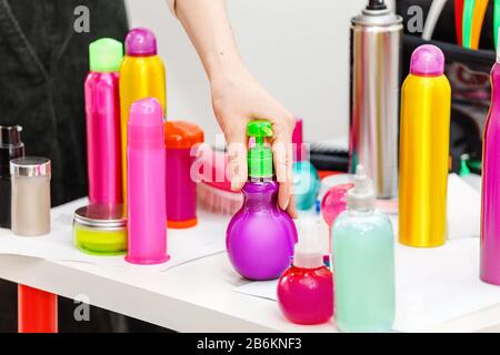 Un ensemble de divers cosmétiques modernes pour le soin des cheveux et pour la fixation de la coiffure dans des boîtes et des sprays dans un salon de beauté Banque D'Images