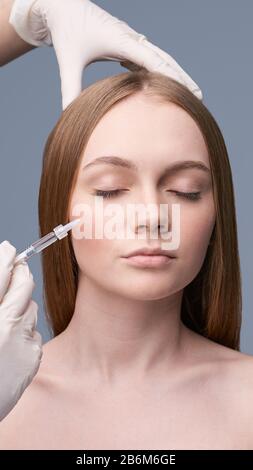 Jeune jolie femme studio portrait. Concept d'injection de cosmologie Banque D'Images