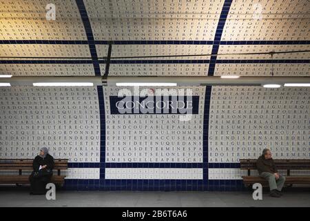 Deux personnes face à la direction opposée sous un panneau lecture Concorde (accord), station de métro Concorde, rive droite, Paris, France, Europe, couleur Banque D'Images