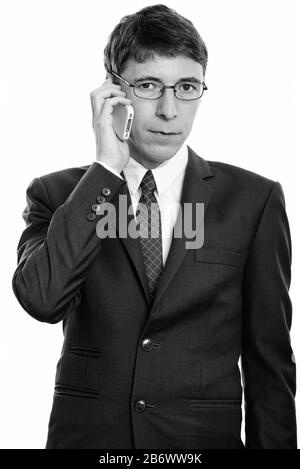 Studio shot of businessman talking on mobile phone Banque D'Images