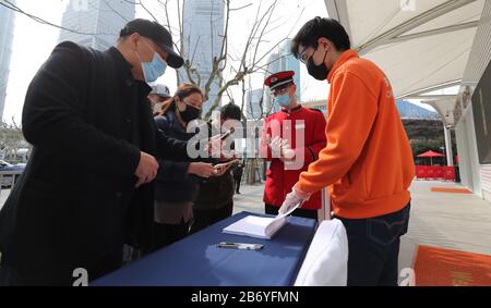 Shanghai. 12 mars 2020. Les touristes scannent un code QR pour s'inscrire à l'entrée de la tour de la Perle orientale de Shanghai, le 12 mars 2020. La tour de Shanghai, le bâtiment le plus élevé de Chine, a rouvert son attraction touristique « Top of Shanghai Observatory » à partir de jeudi. Deux autres sites touristiques ont également commencé à recevoir des touristes de jeudi, dont la tour des perles orientales de Shanghai et la tour Jinmao de Shanghai. POUR ALLER AVEC les paysages de gratte-ciel de 'Hanghai, les monuments à rouvrir' crédit: Fang Zhe/Xinhua/Alay Live News Banque D'Images