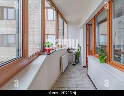 Petit balcon propre et confortable avec fenêtres dans le petit appartement de ville avec des plantes Banque D'Images