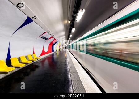 Un train en mouvement partant d'une plate-forme vide à la station de métro Assemblee-nationale, Paris, France, Europe, couleur Banque D'Images