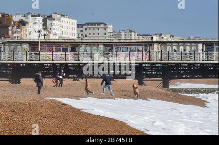 Brighton Royaume-Uni 13 mars 2020 - Les Familles aiment jouer sur la plage au soleil car Brighton est toujours occupé malgré l'épidémie de Coronavirus. Crédit: Simon Dack / Alay Live News Banque D'Images