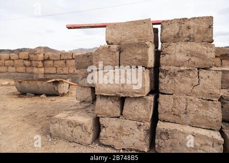 Production maison traditionnelle de briques d'argile brute disposées en piles pour le séchage sur l'usine locale de briques, les briques sont en pile un par un, mur sur l'u Banque D'Images