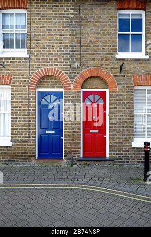 Deux portes avant identiques, une rouge bleue, sur de vieilles maisons mitoyennes sur Brocas Street, Eton Berkshire Angleterre Royaume-Uni Banque D'Images