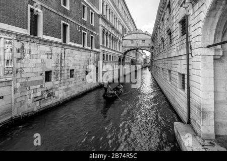 Une télécabine vénitienne typique navigue sur le canal qui passe sous le célèbre Ponte dei Sospiri, Venise, Italie Banque D'Images