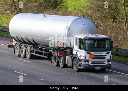 Un navire-citerne de gaz naturel liquéfié ; un navire-citerne de GNL. Un transporteur de gaz hautement sophistiqué avec un système de confinement de la cargaison GNL très spécialisé construit pour le transport de gaz naturels en vrac. Camions de livraison de transport de poids lourds, camion, transport, camion, transporteur de marchandises, Scania Vehicle, industrie européenne du transport commercial, M61 à Manchester, Royaume-Uni Banque D'Images