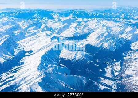 Panorama aérien alpin unique. Blue Planet Earth vue aérienne haute altitude des Alpes italiennes européennes enneigées, vue depuis une cabine d'avion. E Banque D'Images