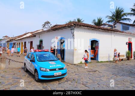 PARATY, BRÉSIL - 14 OCTOBRE 2014 : les gens marchent en voiture de police dans la vieille ville de Paraty (état de Rio de Janeiro). La ville coloniale date de 1667 et Banque D'Images