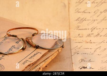 Souvenir - lettres de Grandpa : gros plan d'un coing-nez vintage allongé sur un paquet de lettres anciennes et une feuille manuscrite de papier d'écriture labelé Banque D'Images