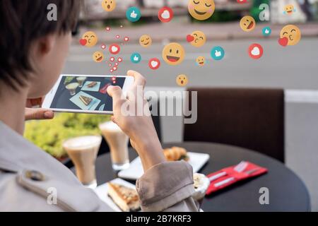 Blogger femme prenant la photo de nourriture sur le téléphone dans le café obtenir des aime, closeup. Banque D'Images