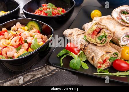 Divers plats mexicains mixtes. Tortillas et salade de crevettes sur table sombre Banque D'Images