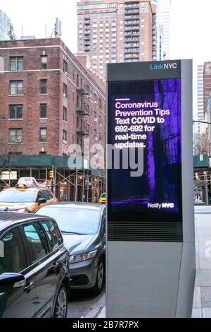 Affichage d'informations numériques LinkNYC de NYC sur East 54th Street avec un avis sur le virus Corona. Banque D'Images