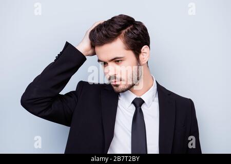 Gros plan photo de bel homme confiant en costume touchant ses cheveux noirs parfaits Banque D'Images