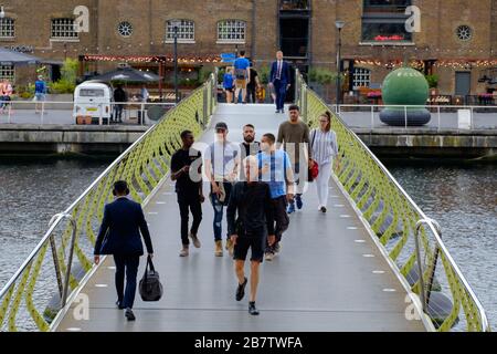 Les gens qui marchent à travers le North Dock Footbridge de Canary Wharf à West India Quay. Londres, Royaume-Uni. Banque D'Images